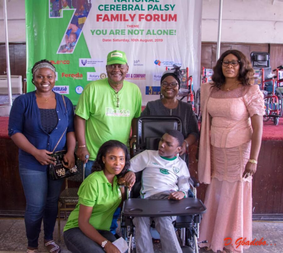 Lady Jumoke Otitoju of Iyaniwura Foundation and AVM Gbadebo with Daniel, recipient of CP Wheelchair with his Mum and sister at the event. 
