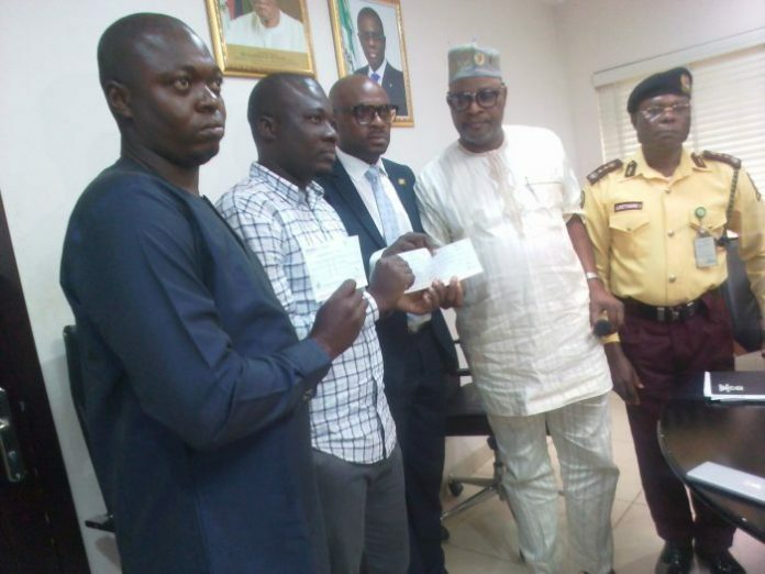 L-R, Mr Adekunle Arogundade, the younger brother of the late Remilekun Arogundade, Mr Babatunde Oyebade, the husband of the deceased, Mr Olawale Musa, the Permanent Secretary, Ministry of Transportation, Mr Oluwatoyin Fayinka, Special Adviser to the Gov. Babajide Sanwo-Olu on Transportation, and Mr Isaac Adetimiro, the Acting General Manager of LASTMA at the presentation of N10 million cheque to the family of the deceased