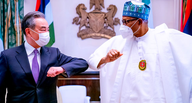 President-Muhammadu-Buhari-greets-Chinas-State-Councillor-and-Foreign-Minister-Mr-Wang-Yi-at-the-Presidential-Villa-in-Abuja-on-January-5-2021.