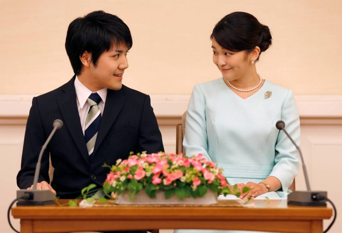 FILE PHOTO: Princess Mako, the elder daughter of Prince Akishino and Princess Kiko, and her fiancee Kei Komuro, a university friend of Princess Mako, smile during a press conference to announce their engagement at Akasaka East Residence in Tokyo