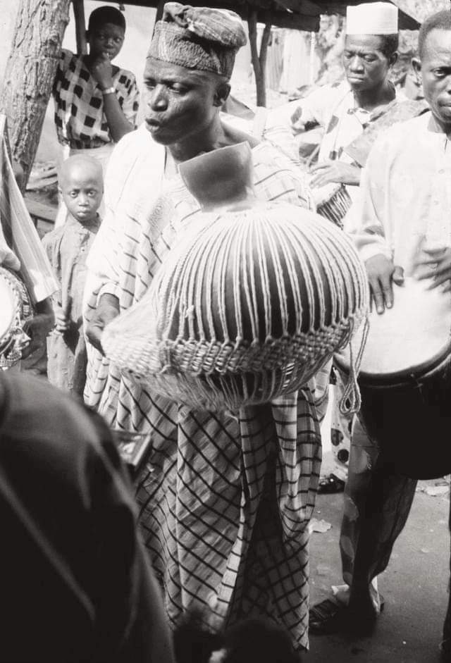 Photo: A Man playing the Olowo Eyo Sekere in Ijebu Ode.
Duckworth E.H 1930-1972