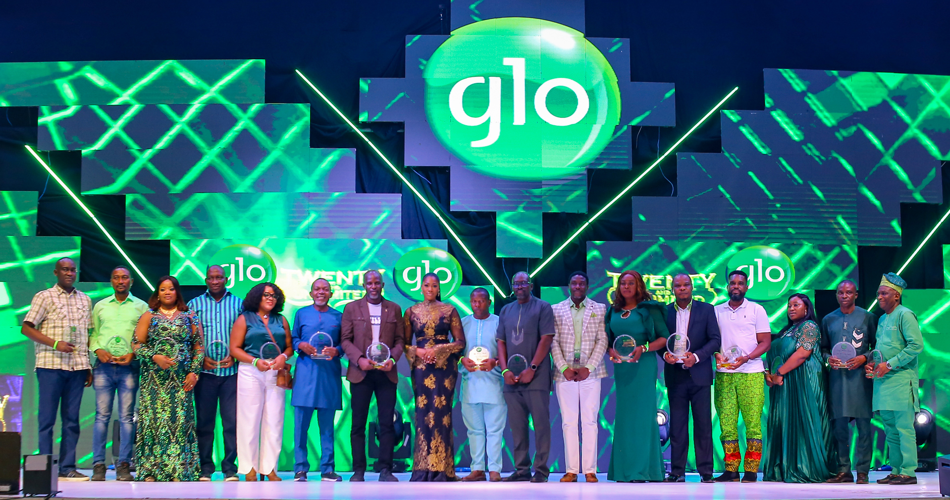 Globacom's Group Executive Director, Folasade Michael-Adenuga (8th from left), with some of the 89 staff members who received mouth-watering sums of money for working for the company for up to 20 years at the Glo Staff Party held on Saturday night at Eko Hotel & Suites in Lagos.