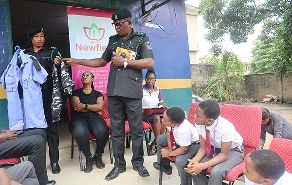 ASP Robert Asiba explaining the different uniforms of the police from Monday to Friday to the pupils of Newfield School